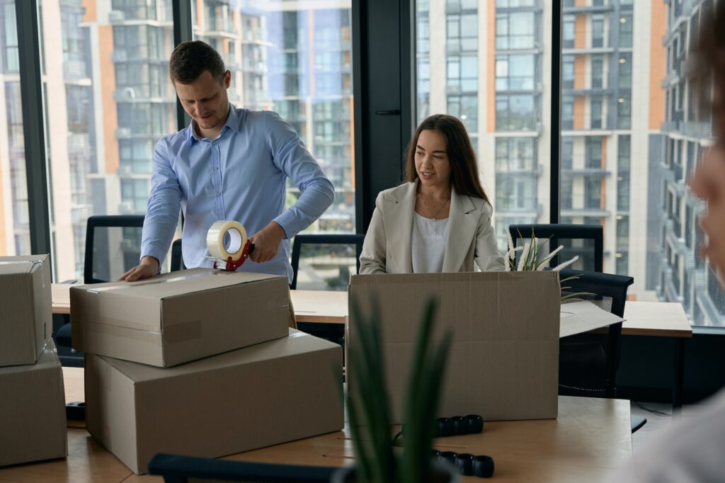 Young company employees preparing for office move